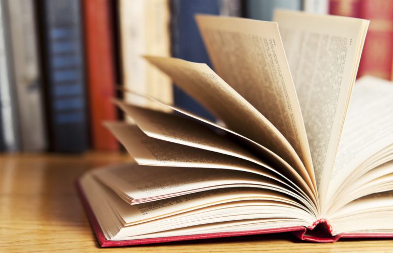 A pile of books with library on the back