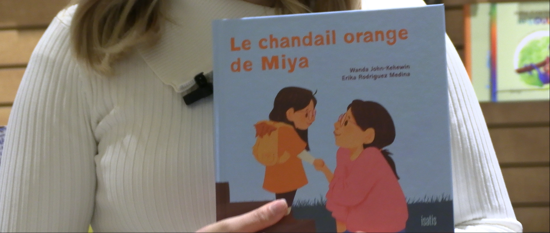Le chandail orange de Miya. (Photo 2M.Media – Corinne Prince)